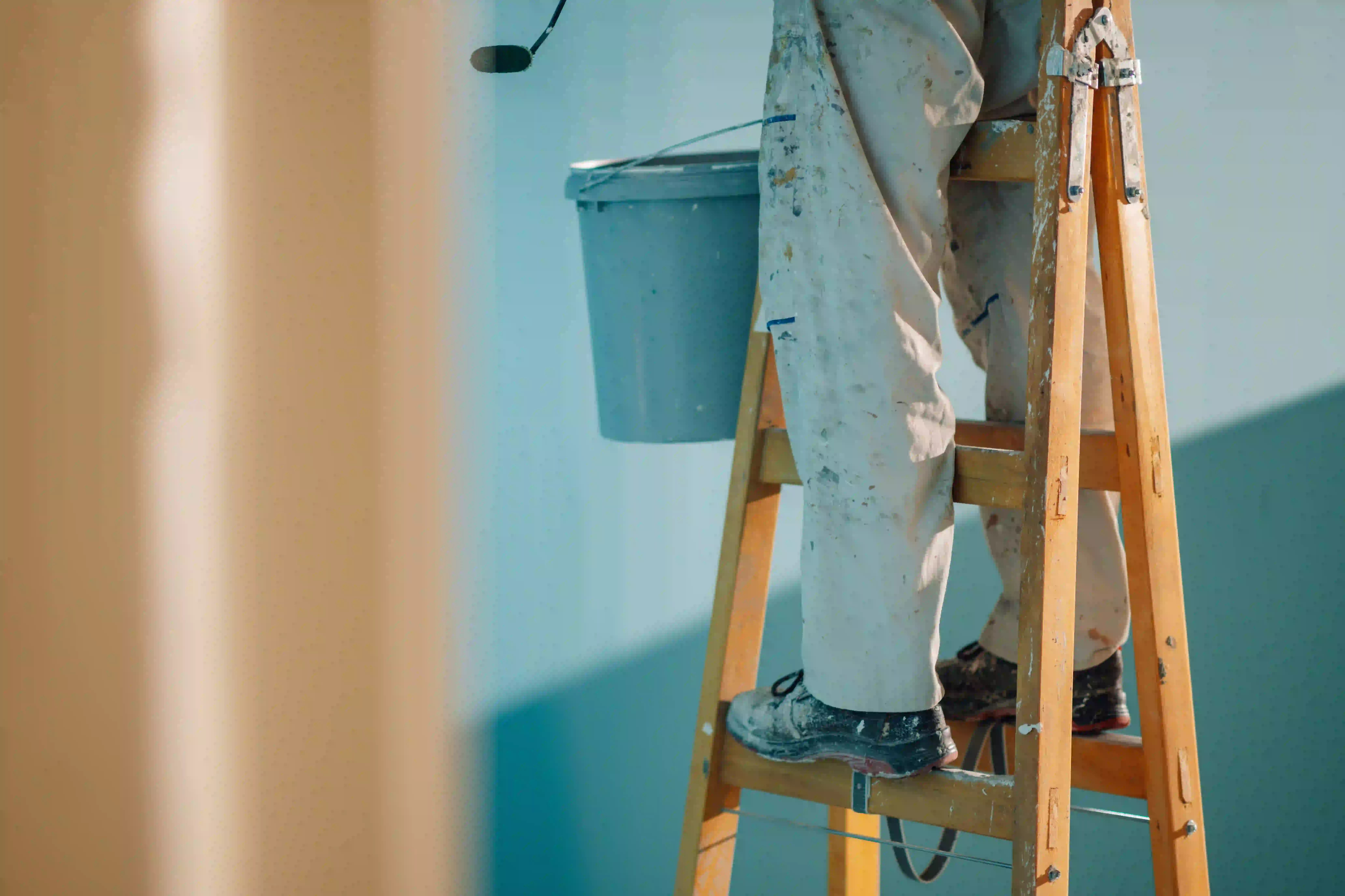 Professional painter on ladder